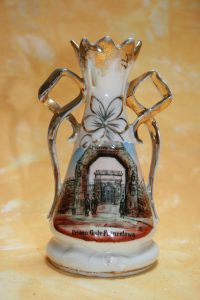 Sinister tourism - a souvenir of the gates of Princetown Prison on bleak Dartmoor. The image shows the outer and inner gates, wardens and prisoners. The piece is made in Germany, 15cm high, c1890.